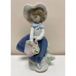 A Lladro figure - Girl with basket of flowers