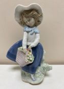 A Lladro figure - Girl with basket of flowers