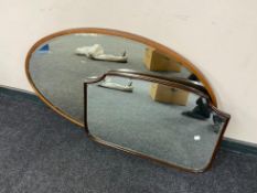 An antique oval framed bevelled mirror together with an antique mahogany bevelled mirror