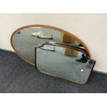 An antique oval framed bevelled mirror together with an antique mahogany bevelled mirror