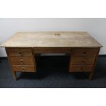 A mid century teak twin pedestal desk