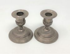 A pair of Victorian squat silver candlesticks, London 1892,
