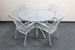 A circular metal patio table and four chairs