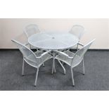 A circular metal patio table and four chairs