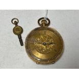 A small fob watch with 18ct gold outer case and key.