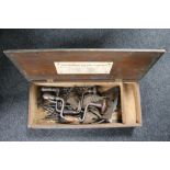 A vintage wooden tool box, hand tools including drill bits,