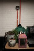 A garden rake and shovel, plastic Christmas tree stand, galvanized bucket and watering can, lantern,