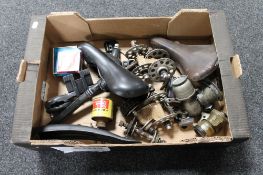 A box of vintage bicycle equipment to include Carbide lights, Brooks saddle,