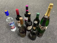 A tray of nine assorted bottles of alcohol; Martel Cognac, Cockburn's Port, Harvey Bristol Cream,