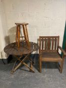 A circular teak garden table,