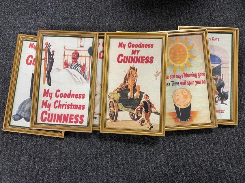Seven gilt framed Guinness advertisements