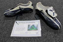 A pair of blue and white Umbro football boots, signed in silver marker pen by Alan Shearer, size 9,