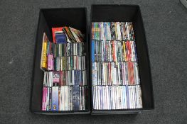 Two storage boxes containing DVD's and CD's