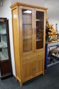 A contemporary oak Morris double door display cabinet