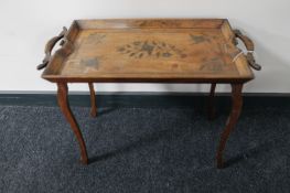 A folding eastern hardwood bed table with brass inlay