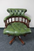 A green button leather swivel captain's armchair