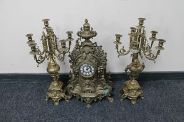 A three piece continental brass clock garniture