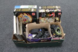 A box of four jigsaws, assorted cameras, leads, remote controls,