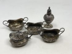 An ornate Victorian five piece silver condiment set, Walker & Hall,