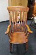 An antique pine farmhouse kitchen armchair