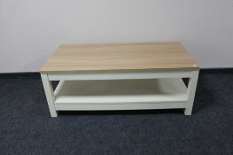 A two tier coffee table on painted base