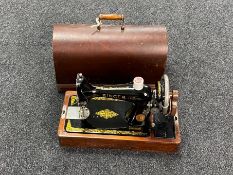 A cased vintage Singer hand sewing machine