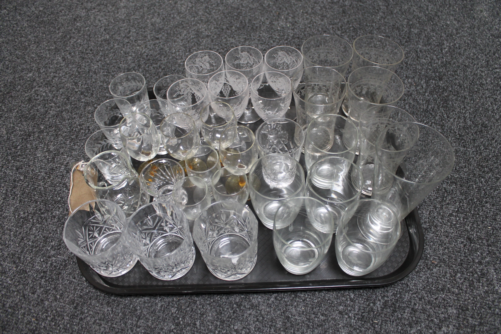 A tray of antique and later drinking glasses including etched examples and a Stuart Crystal vase