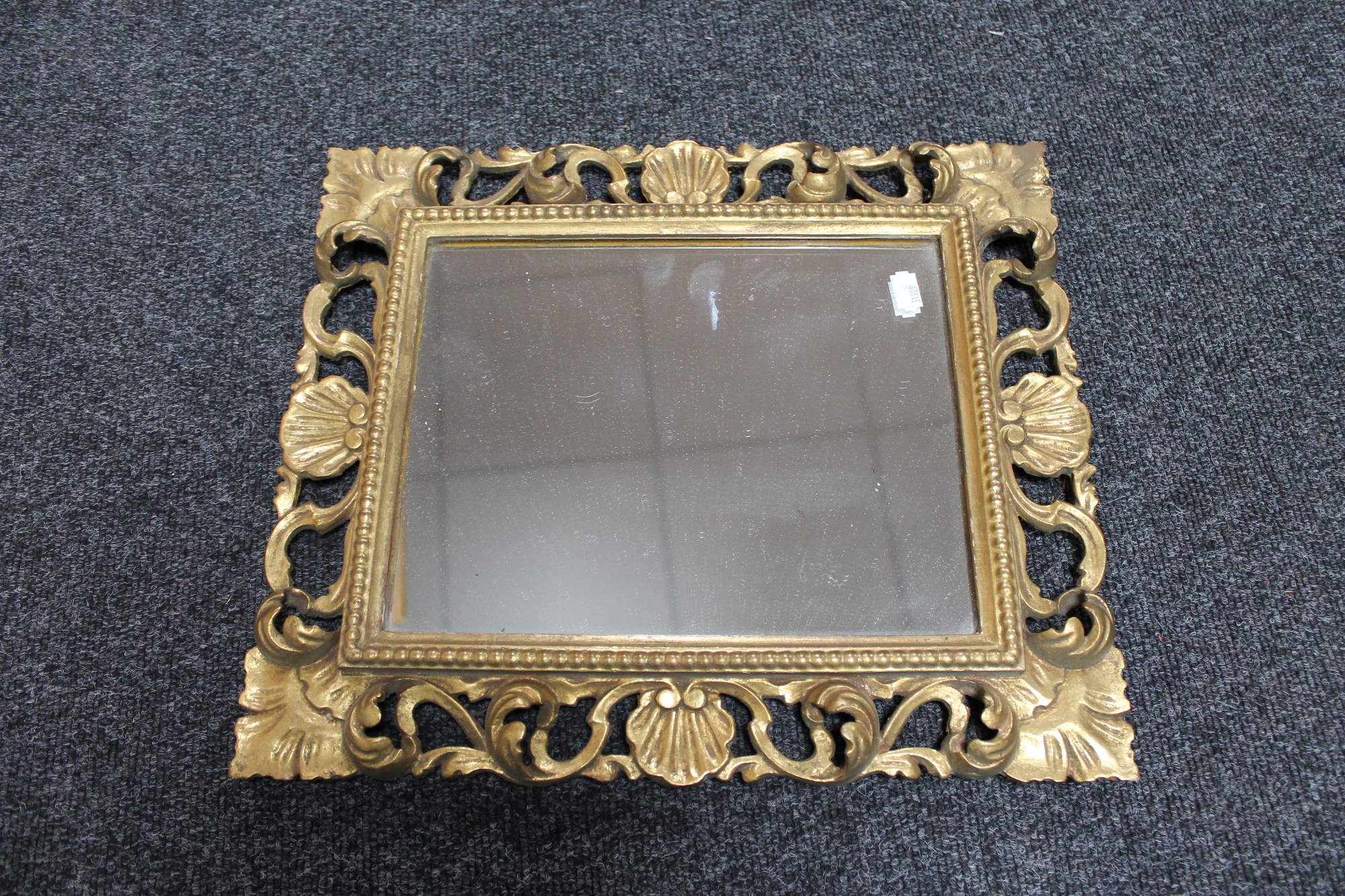 A Victorian decorative gilt framed mirror, height 42cm,