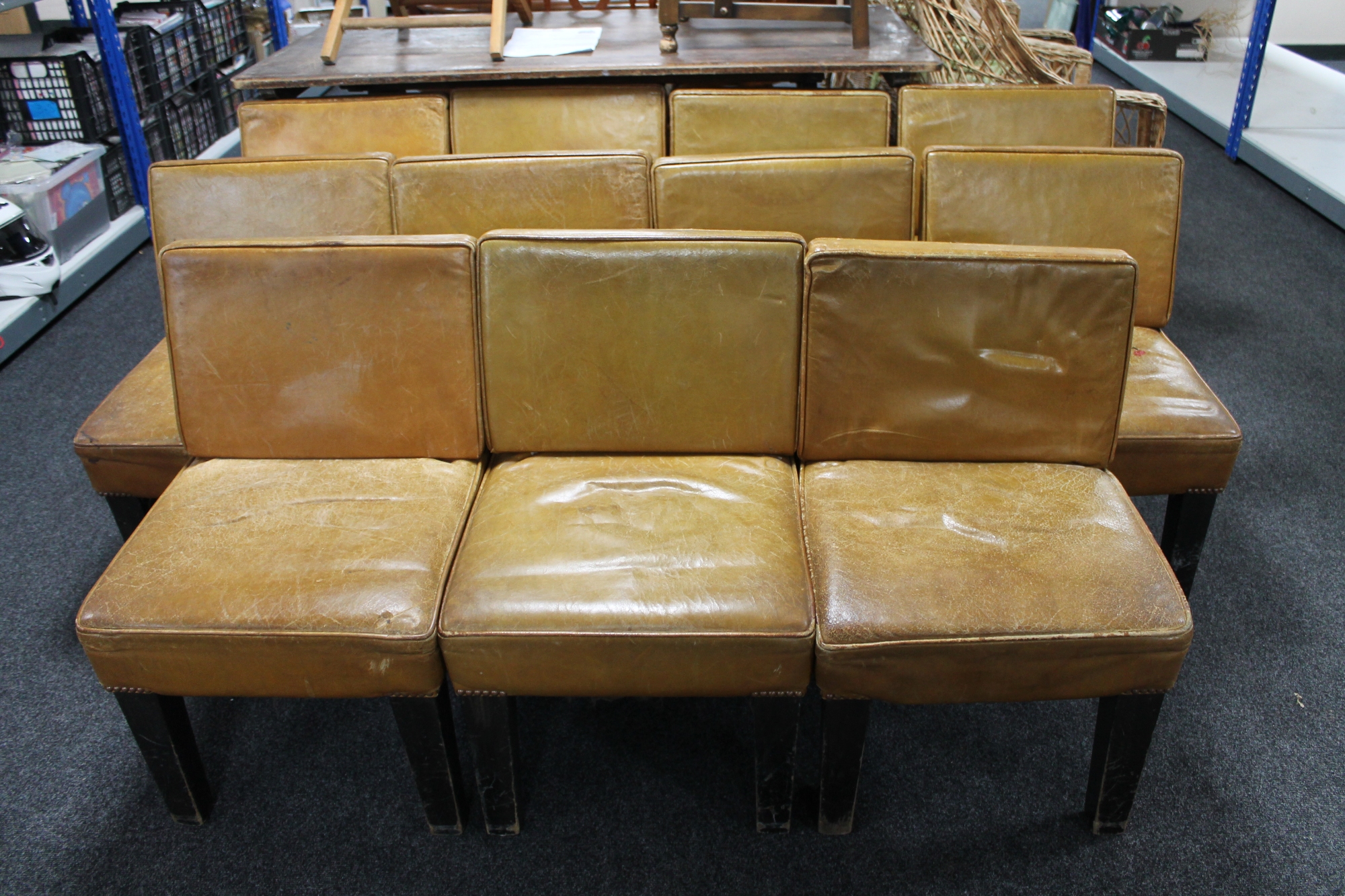 Eleven tan leather upholstered function room chairs