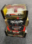 A boxed Burago 1:18 die cast Dodge Viper together with three further boxed Burago 1:24 scale die