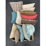Two boxes containing twelve assorted cushions and a rug