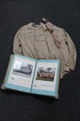 A folder of scouting memorabilia, with two scout's shirts,