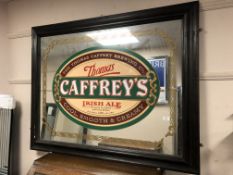 An antique and later overmantel mirror, with Thomas Caffrey's Irish Ale advertising,