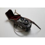A Rollop automatic camera in leather case