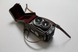 A Rollop automatic camera in leather case