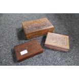 An eastern brass inlaid trinket box and two heavily carved cigarette boxes