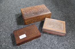 An eastern brass inlaid trinket box and two heavily carved cigarette boxes