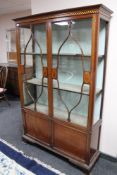 An Edwardian inlaid double door display cabinet CONDITION REPORT: One glass panel