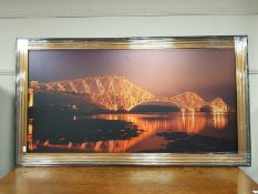 A framed print of a bridge scene