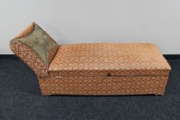 An Edwardian storage chaise longue in floral fabric