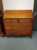 A George III mahogany bureau fitted five drawers,