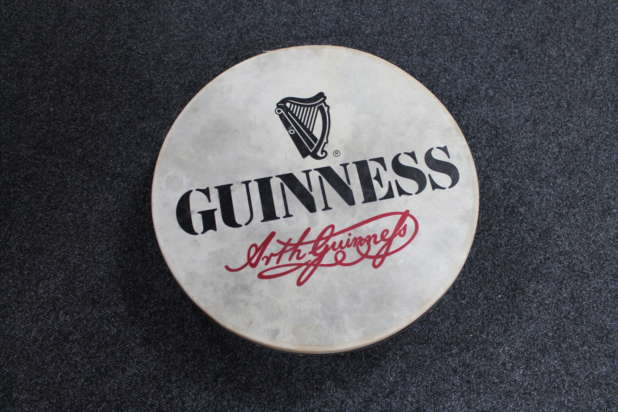 A Bodhran drum with Guinness advertisement