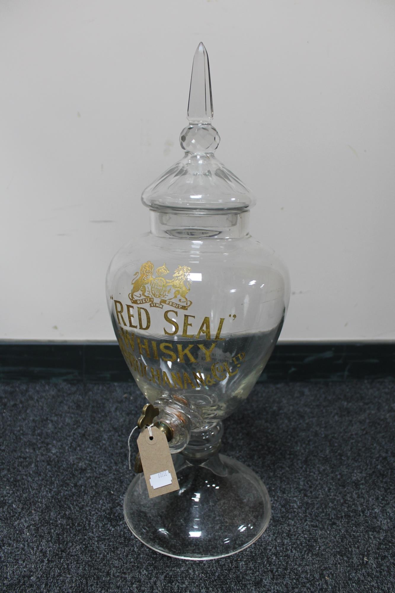 A Red Seal Whisky, Jas. Buchanan & Co., Ltd., glass dispenser with brass tap.