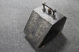 An antique metal coal receiver