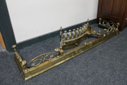 An antique brass extending fire curb and a brass fire front