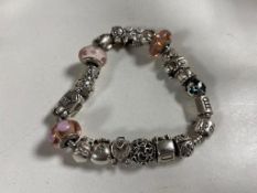 A silver Pandora style charm bracelet with charms