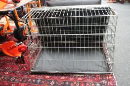 A folding metal dog cage