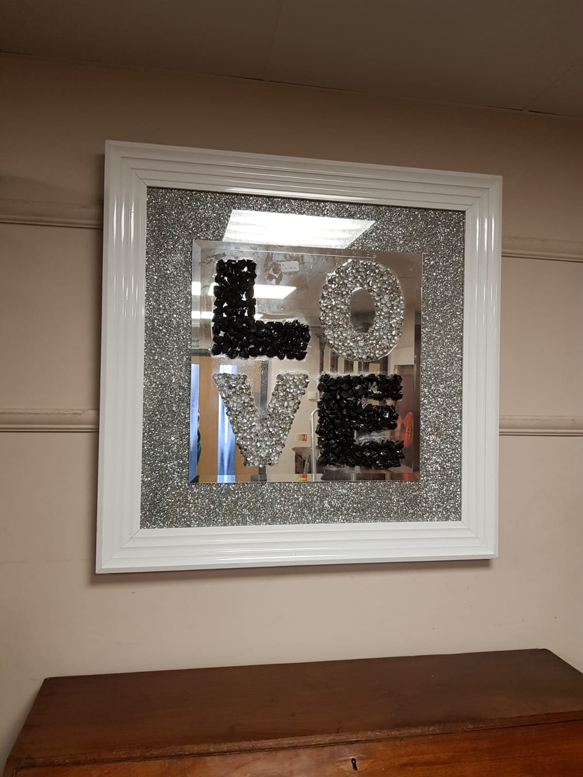 A contemporary framed 'Love' mirror
