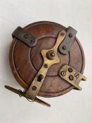 An antique wooden fishing reel