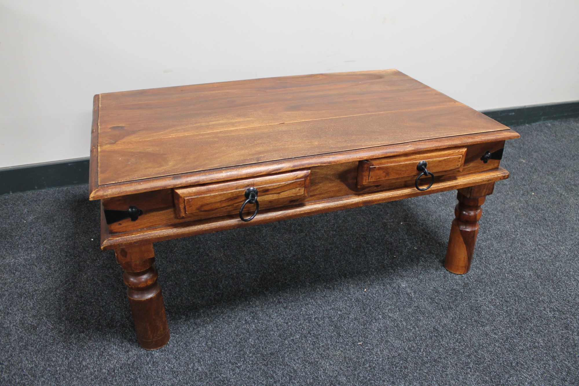A sheesham wood coffee table fitted two drawers